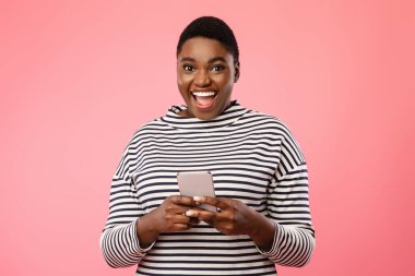 Heyecanlı Artı Boyutlu Afrikalı Kadın Pembe Arkaplan Üzerinde Cep Telefonu Kullanıyor