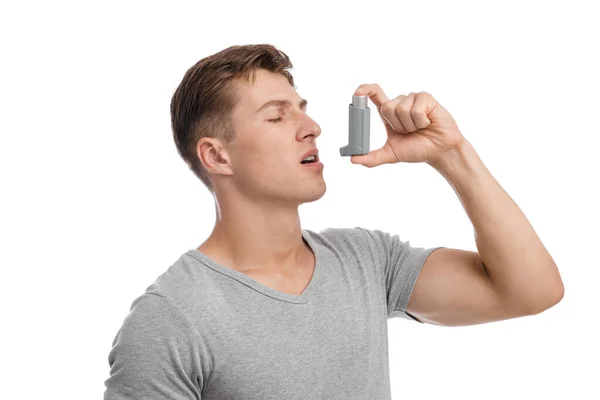 Calm concentrated millennial caucasian attractive male suffering from asthma and spraying inhaler in mouth — Stock Photo, Image
