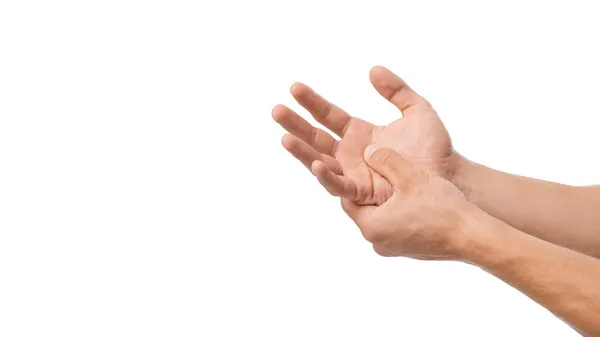 Unrecognizable millennial caucasian male presses his hand to sore spot and suffers from pain in arm — Stock Photo, Image