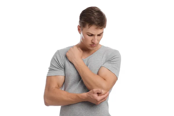 Sad young caucasian handsome guy massaging sore spot, suffer from elbow pain — Stock Photo, Image