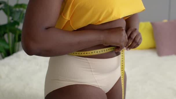 Weight Loss Concept. Black Overweight Woman Checking Waist Size With Measuring Tape — Stock Video