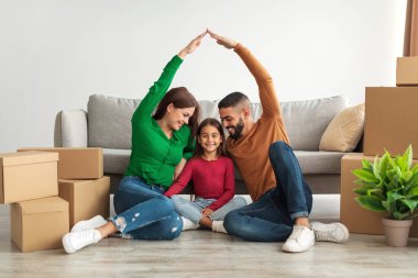 Cheerful parents making symbolic roof of hands above happy daughter clipart