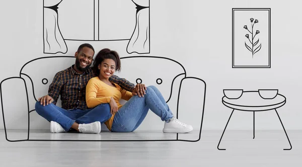 Cheerful black couple planning and imagining new home interior