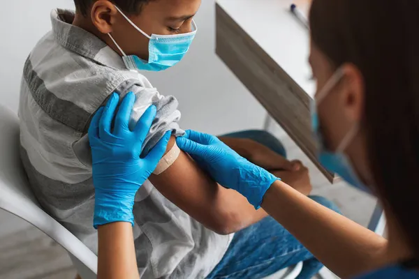 Niño afroamericano vacunado contra Covid-19 en interiores, cultivado — Foto de Stock