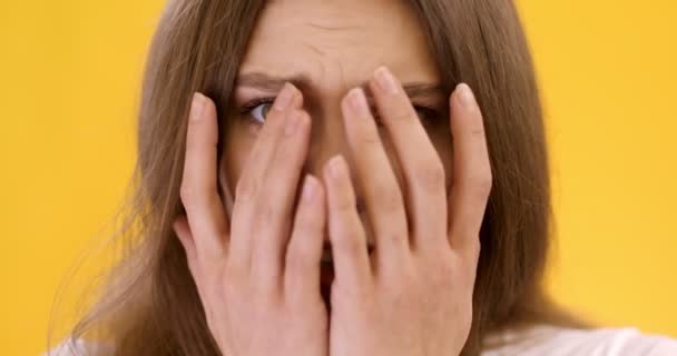 Victim of abuse and domestic violence. Close up portrait of young scared woman feeling terrified, hiding her face — Stock Video