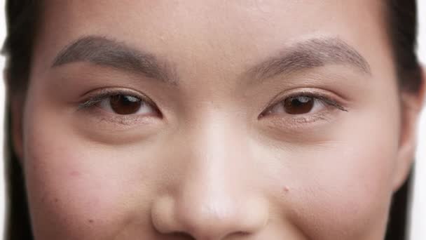 Closeup Of Young Asian Female Looking At Camera, White Background — Stock Video