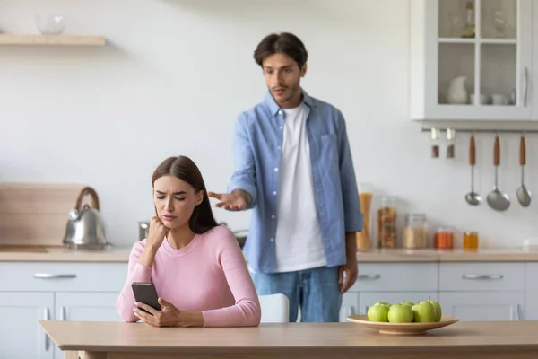 Infeliz millennial caucásico marido jura esposa en minimalista cocina interior — Foto de Stock