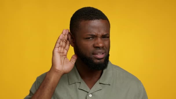 Curious African American Man Keeping Hand Near Ear, Trying To Overhear Information — Stock Video