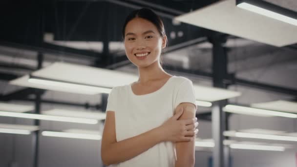 Mujer vacunada posando brazo conmovedor después de la vacunación en la oficina moderna — Vídeos de Stock