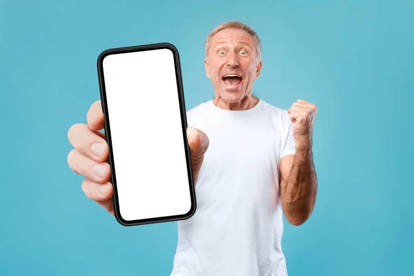 Ragazzo eccitato appoggiato sullo schermo dello smartphone vuoto e gesticolando sì — Foto Stock