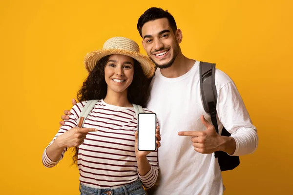 Χαρούμενα ταξιδιώτες της Μέσης Ανατολής Ζευγάρι δείχνοντας Smartphone με λευκή οθόνη — Φωτογραφία Αρχείου