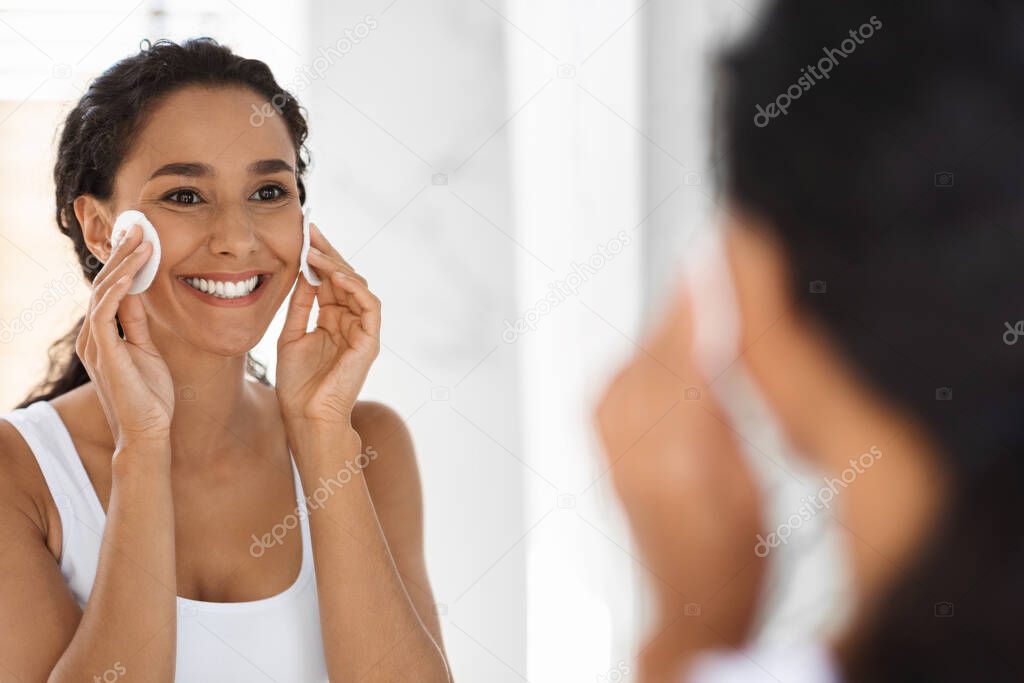 Beauty Routine. Smiling Woman Using Cotton Pads For Cleansing Skin In Bathroom