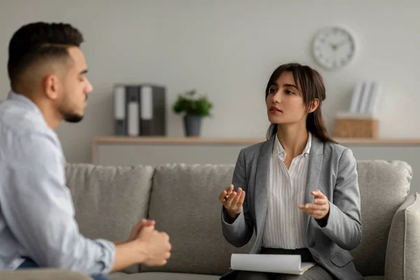 Mental health care concept. Arab guy speaking to psychologist, listening advices and explaining about his problem — Stock Photo, Image