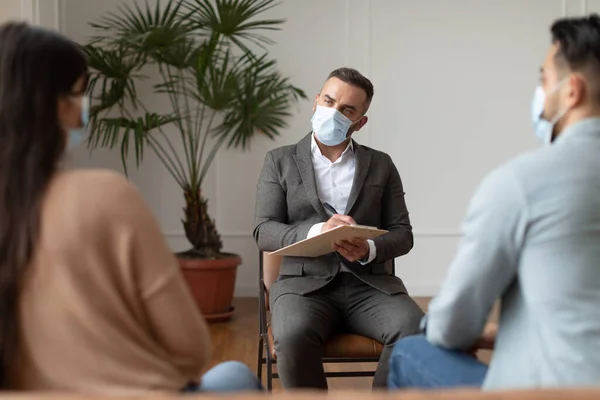 Pareja teniendo sesión de terapia con el terapeuta, hombre tomando notas —  Fotos de Stock