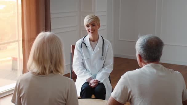 Glada doktor Lady Consulting Senior par under utnämning Inomhus — Stockvideo