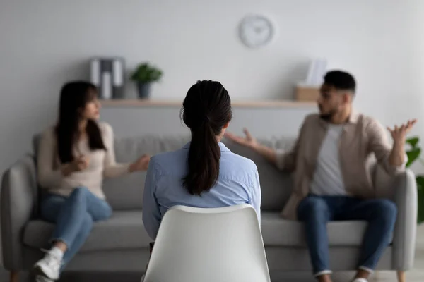 Marital therapy. Professional psychologist sitting back to camera during meeting with arab couple, selective focus — Stock Photo, Image