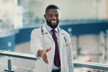 Yakışıklı, gülümseyen Afro-Amerikan bir doktorun portresi.