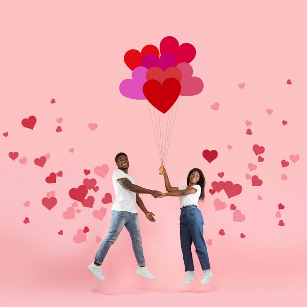 Young Romantic Black Couple Flying Holding Balloons — Stock Photo, Image