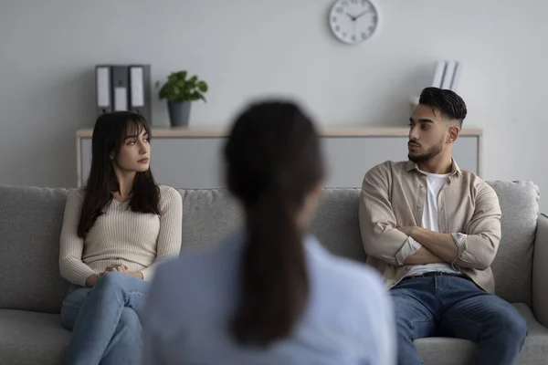 Back view of female psychologist giving therapy session to arab couple sitting on couch and looking at each other — Stock Photo, Image