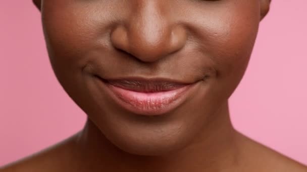 African Womans Smile With Braces Snapping Teeth, Pink Background, Closeup — Stockvideo