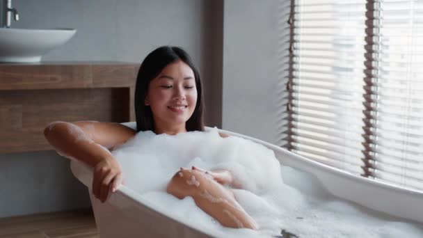 Asian Female Taking Bath With Foam Washing Body In Bathroom — Stock Video