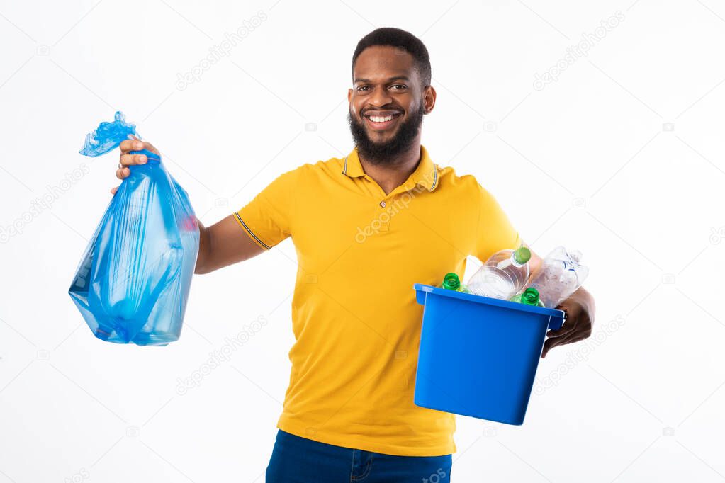 Black Man Holding Garbage Bag And Box Over White Background