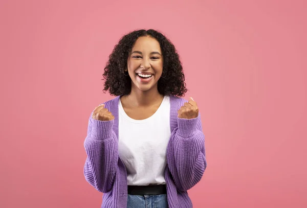 Overjoyed young African American woman gesturing YES in joy, celebrating success over pink studio background — Foto de Stock