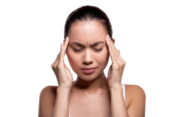 Upset millennial korean lady massaging her temples — Stockfoto