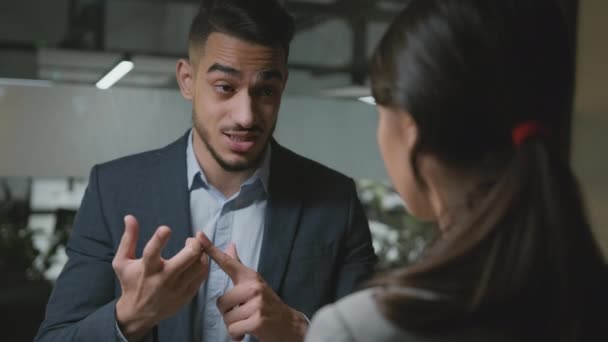 Gender discrimination and bullying. Young angry irritated arab man manager reproaching with female colleague — Stock videók