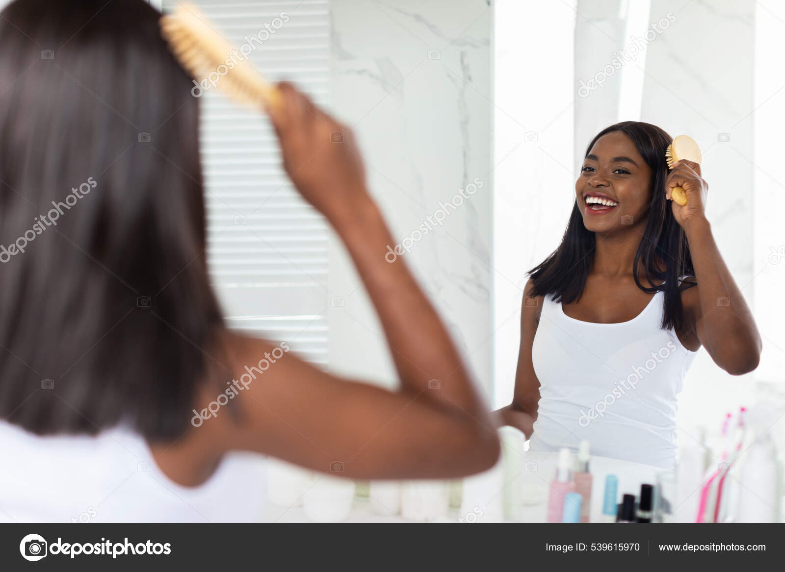 Beautiful African American Woman Combing Her Hair With Bamboo