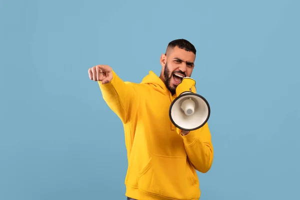 It is your chance. Middle eastern guy with megaphone making announcement, saying something loud and pointing at camera — Fotografia de Stock