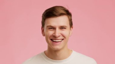 Man Smiling And Laughing Looking At Camera Over Pink Background