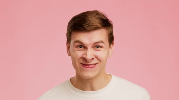 Angry Millennial Man Clenching Teeth Expressing Aggression Over Pink Background — Stockvideo