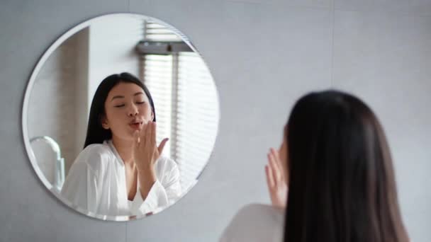 Asian Female Blowing Kiss To Reflection In Mirror In Bathroom — Vídeo de Stock