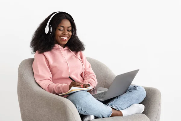 Positive black woman attending webinar, using laptop and headset — ストック写真