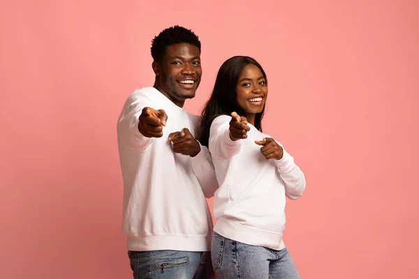 Cute positive black couple gesturing together on pink — Foto Stock