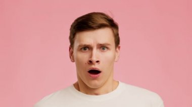 Shocked Man Looking At Camera Shaking Head Over Pink Background