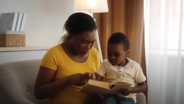 Kids Development. Caring Black Mother Teaching Little Son Reading At Home — Stock video