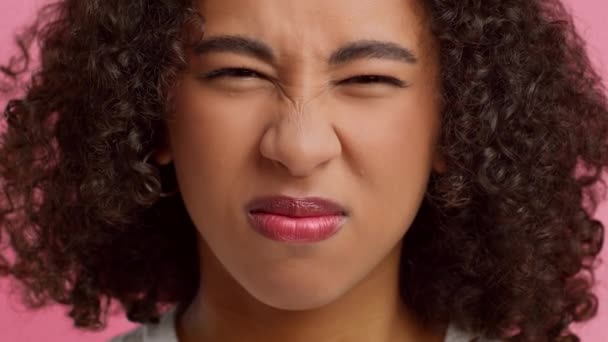 Disgusted African American Young Woman Smelling Unpleasant Stink, Pink Background — Stok video