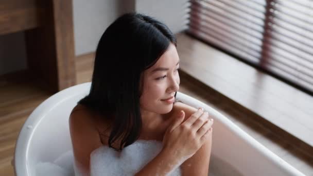 Japanese Woman Applying Scrub Caring For Body Bathing In Bathroom — Vídeo de Stock
