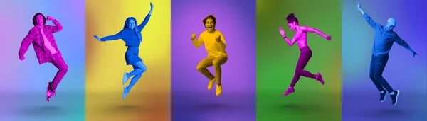 Excited millennial diverse people jumping and shouting in joy over colorful neon studio backgrounds, panorama — Stock Fotó