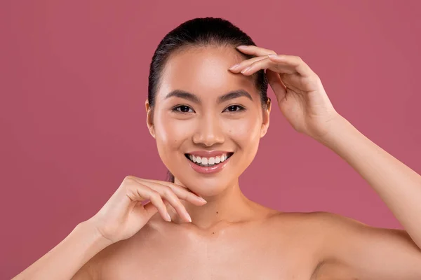 Cheerful attractive asian lady posing topless on studio background — Zdjęcie stockowe