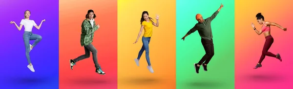 Круті молоді різноманітні люди стрибають вгору і виражають хвилювання на кольоровому неоновому студійному фоні, повної довжини — стокове фото