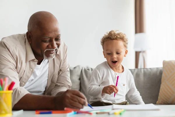 Black Little Boy And His Grandfather Sketching Together At Home —  Fotos de Stock