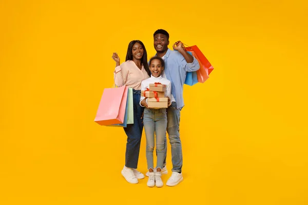 Pessoas negras felizes segurando sacos de compras e caixas de presente — Fotografia de Stock