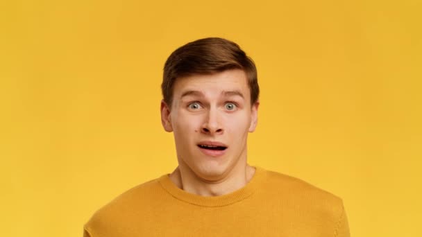 Emotional Man Grimacing Expressing Disgust And Shock Over Yellow Background — Stock Video