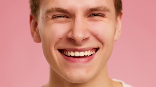 Cropped Shot Of Guy Smiling Looking At Camera, Pink Background — Stockvideo