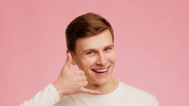 Man Gesturing Call Me Holding Hand Like Phone, Pink Background — Wideo stockowe