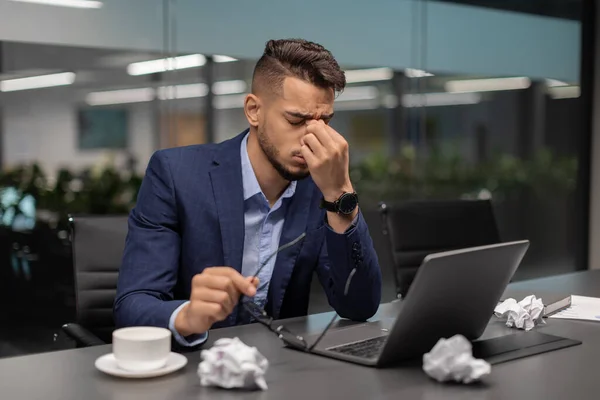 Tired arab guy CEO working on laptop at office — Stock Fotó