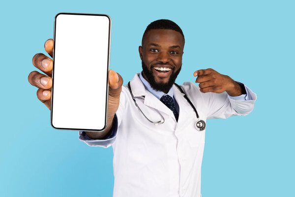 Excited African American Doctor Showing Smartphone With Blank Screen At Camera, Mockup
